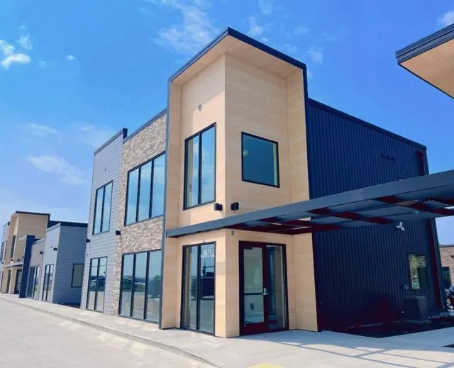 Commercial building with wood-look siding, stone columns and navy metal panels